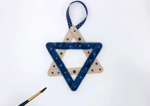 Create a Star of David ornament for Hanukkah with colored sand and glue!  #HanukkahCrafts #Hanukkah